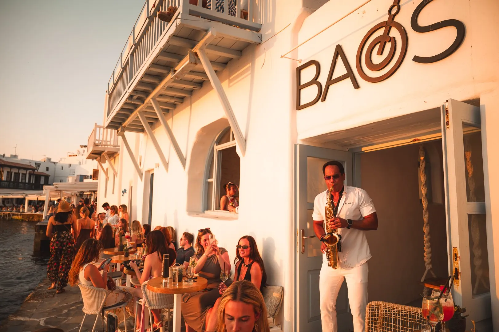 The entrance to BAO'S in Little Venice, Mykonos, busy in the afternoon