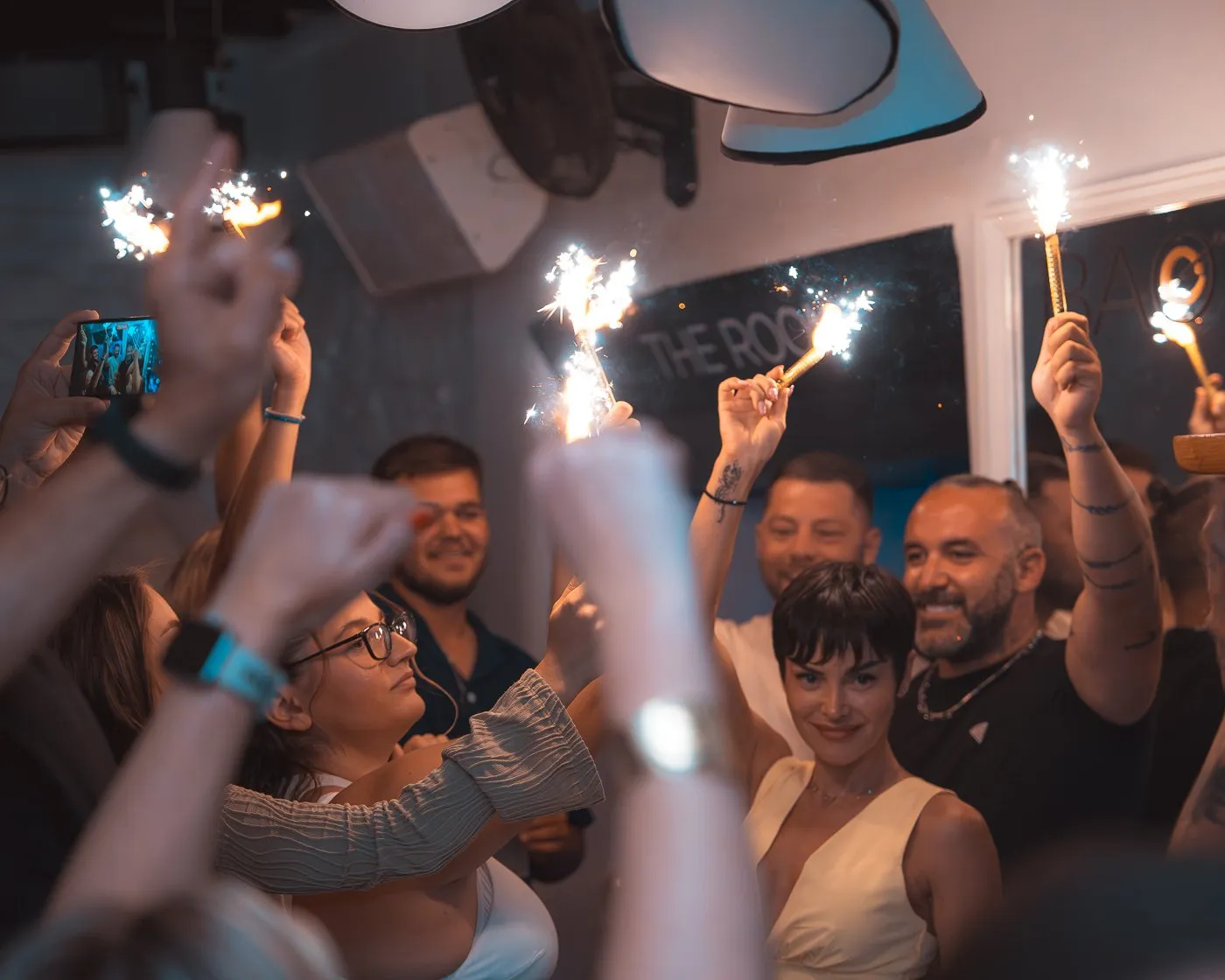 Sparklers raised over a celebrating group at BAO'S