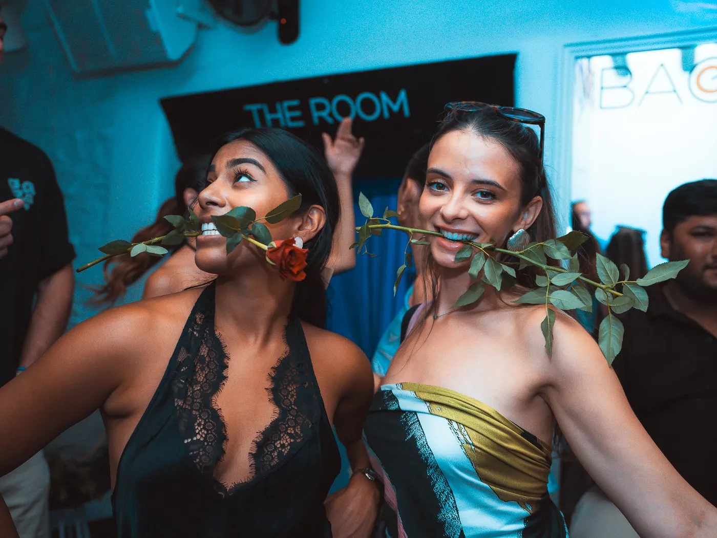 Two guests in front of The Room sign at BAO'S during a party